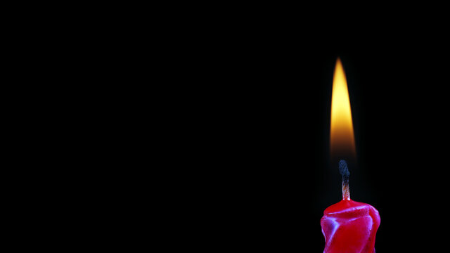 burning candle on black. burning candle flame close-up. copy space