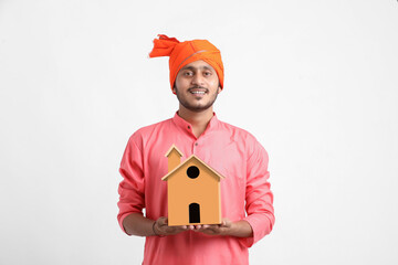 Home loan concept. Indian farmer posing on white background.