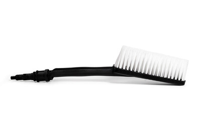 Power washer brush attachment. Large black brush with white bristles or tufts. Used to clean soft outdoor surfaces with a high pressure cleaner. Isolated on white. Selective focus.