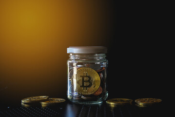 Gold bitcoin and money coin in glass bottle. Crypto currency and finance concept. 