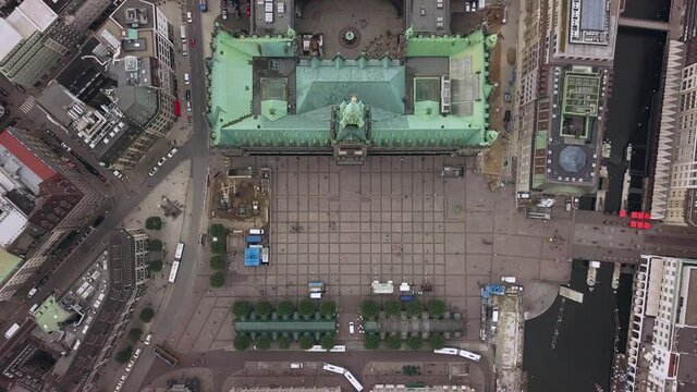 flying above the town hall of hamburg city germany, gaining hight, looking strate down