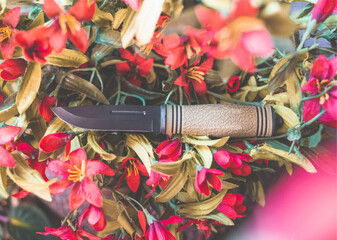 Top down photo of a knife in flowers.