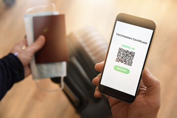 Man holding passport, face mask and certificate of vaccination against Covid-19, a negative PCR test or recovery from Covid-19. Business and tourism concept of travel during coronavirus pandemic.