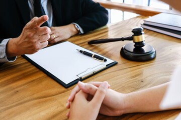 Lawyer Legal counsel presents to the client a signed contract with gavel and legal law. justice and lawyer Business partnership meeting concept.