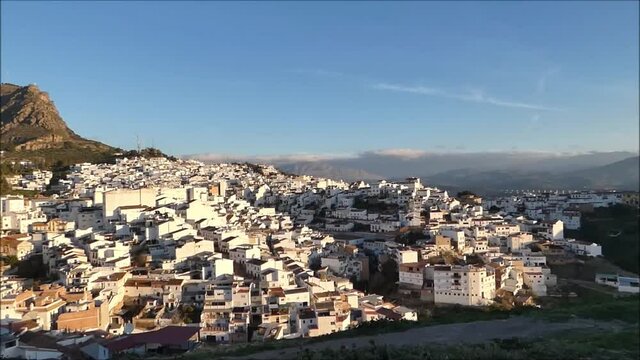 White village of Alora viewed from castle hill. White washed houses climbing hillside in sunny Andalusian village of &Aacute;lora