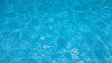 Fototapeta na wymiar Abstract pool water. Swimming pool bottom caustics ripple and flow with waves background surface of blue swimming pool
