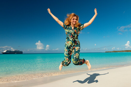 Happy Person Jumping On The Beach