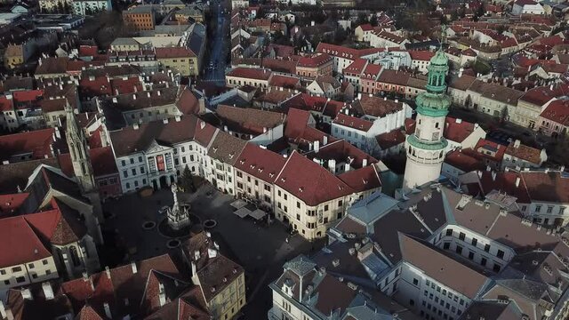 Cinematic aerial drone footage of the charming historical Main Square, Fire Tower downtown Sopron, a major tourist destination in Győr-Moson-Sopron County, Western Transdanubia in Norhwestern Hungary