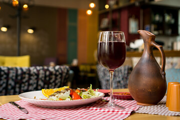 Grilled ribeye beef steak with red wine, herbs and spices on wooden table