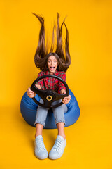 Full length photo of young excited girl happy smile hold steering-wheel drive trip road speed...