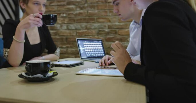 Gropu of business people meeting in cafe and working on project