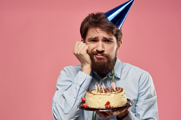 man with a cap on his head cake holiday decoration pink background