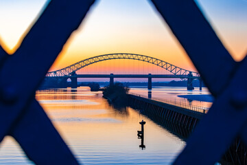 Silver Jubilee Bridge framed through an iron bridge support