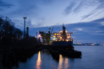 MARITIME TRANSPORT - A merchant vessel at a transshipment quay in a seaport 