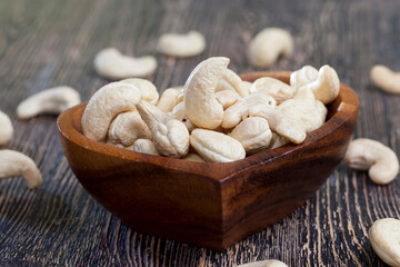 Fototapeta na wymiar crunchy cashew nuts in a heart shaped bowl