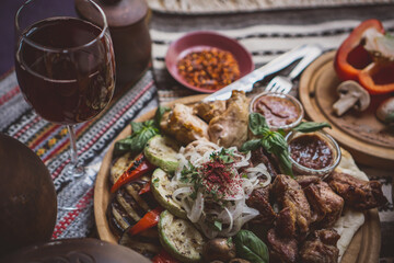 The richly laid table dishes of Georgian cuisine, lots of delicious food,wine,fruits and roasted meat