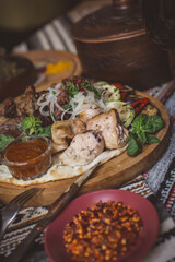 The richly laid table dishes of Georgian cuisine, lots of delicious food,wine,fruits and roasted meat