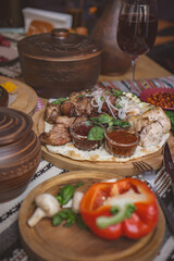 The richly laid table dishes of Georgian cuisine, lots of delicious food,wine,fruits and roasted meat