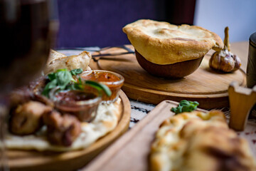 The concept of oriental cuisine. Homemade georgian Uzbek pilaf or plov from lamb served in cast iron cookware. Copy space.
