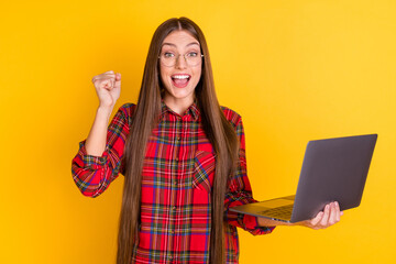 Portrait of nice hooray brunette long hairdo lady hold laptop wear spectacles red shirt isolated on vivid yellow color background