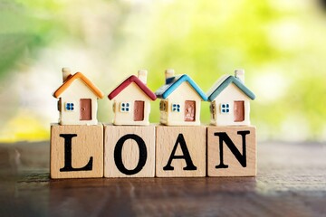 home loan concept with miniature house model on wooden blocks, real-estate concept