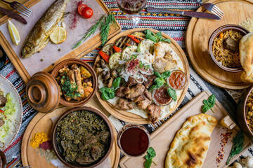 A lot of food on the wooden table. Georgian cuisine. Top view. Flat lay . Khinkali and Georgian dishes