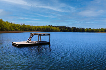 A beautiful lake with dark blue water and a diving area.