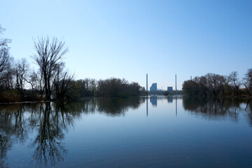 beautiful blue lake with chimneys in the background