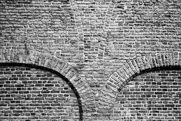 Old arches in brickwork in Delft, The Netherlands, a historic city.