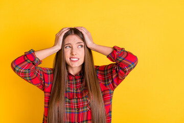 Portrait of attractive worried girl wearing checked shirt oops wrong decision copy space isolated over bright yellow color background