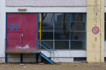 Obraz premium Facade from sixties with large window and loading bay in the netherlands. Dutch architecture from the 60s.