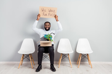 Full length body size photo of smiling man waiting for interview to get a job keeping box with belongings ready to work for food
