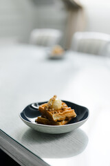 breakfast of Viennese waffles with mousse on the table at the hotel