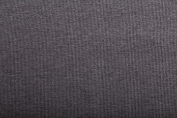 Knit grey fabric texture, background or backdrop. Textile, scarf or sweater textured surface. Warm accessories, clothing, fashion concept.