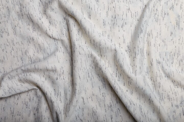 Texture of white cotton wrinkled fabric with dark threads inclusion, background or backdrop. Clothing, sewing, gressmaking, haberdashery. Copy space.