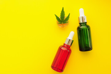 Cannabis cosmetics, cbd oil. Marihuana extract in cosmetology. Flat lay, yellow background. Home relaxation, spa recreation, pastime therapy.