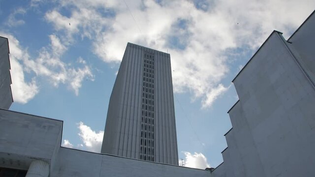 Old skyscraper building blue sky birds push in forward camera movement