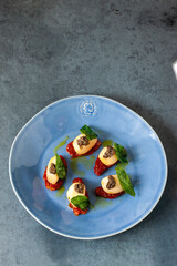aperitivos y pinchos, tapas de España, pimientos del piquillo con trufas en plato azul. appetizers and pinchos, tapas from Spain, piquillo peppers with truffles on blue plate.