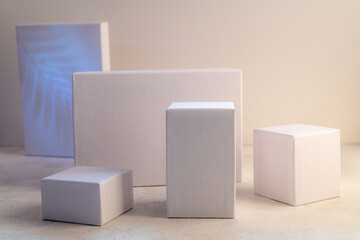 White empty stands on light background. Blank unbranded shopfront. Showcase for cosmetic products. Product advertisement. Cosmetology and beauty concept