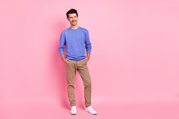 Fototapeta na wymiar Full size photo of brunet optimistic guy look empty space wear blue shirt pants sneakers isolated on pink color background