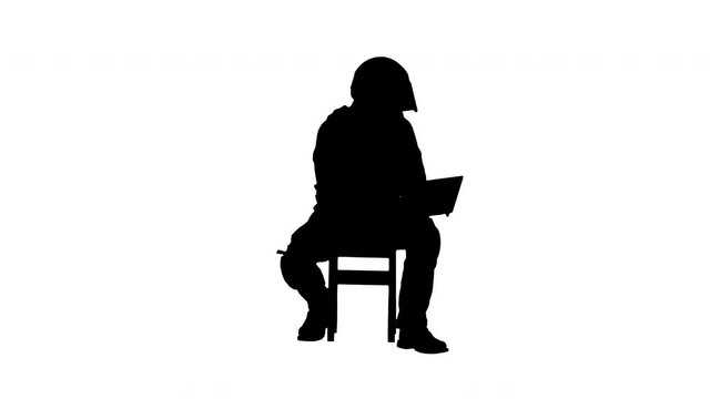 Silhouette Riot police officer sitting and using laptop.