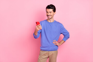 Photo of young cheerful man happy positive smile look read browse cellphone blogger isolated over pastel color background