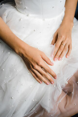 the bride's hands are on the dress