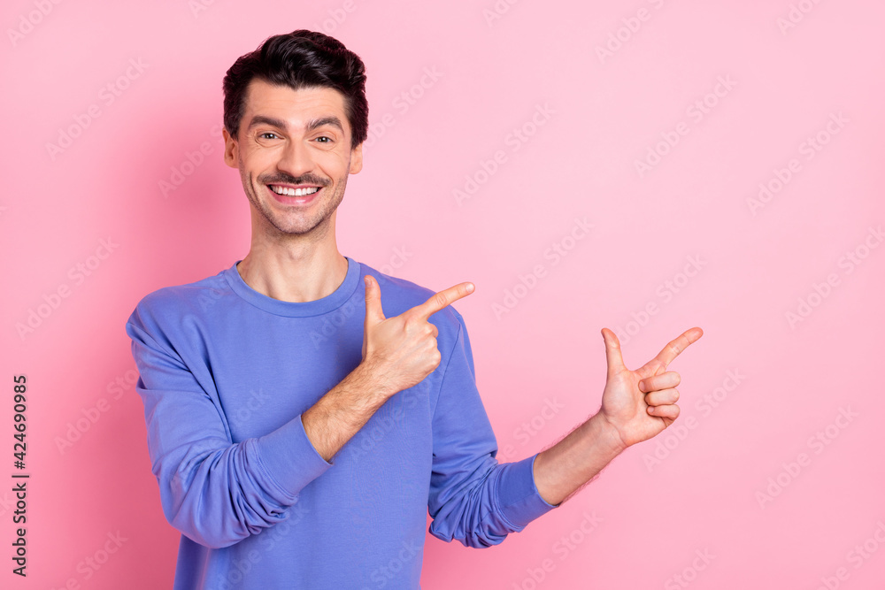 Sticker Photo of young handsome man happy positive smile indicate fingers empty space ad promo advise isolated over pink color background