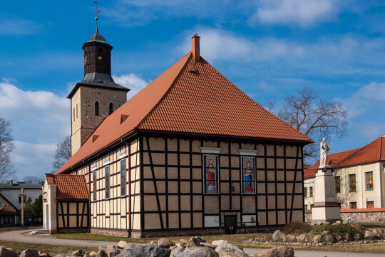An example of a half-timbered wall (Prussian Wall)  used in religious architecture. Made on a sunny day. object against the blue sky. City of Pisz, Poland