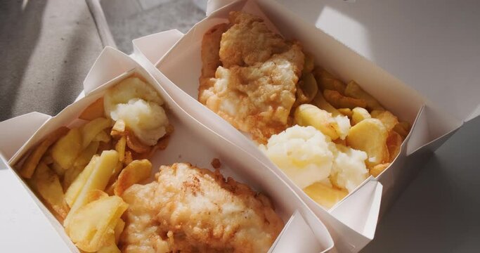 Top view of traditional Greek fried cod fish in card boxes for delivery, mediterranean cuisine, Greece March 25 food tradition. 