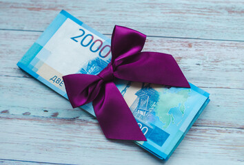 paper money with a purple bow on top. russian rubles