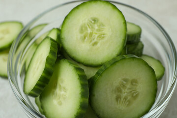 Bowl with ripe cucumber slices, close up