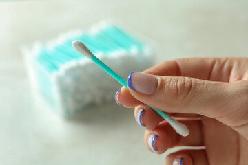 Female hand hold cotton swab, close up