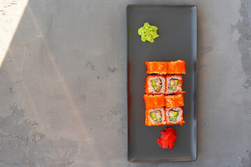California sushi roll served on gray background